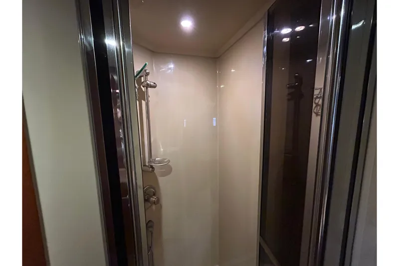 Slide: The Image of Shower area inside 2006 Cruisers Yachts 520 Express, featuring modern fixtures and lighting. - 33