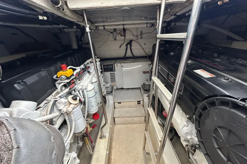 Slide: The Image of Engine room of 2006 Cruisers Yachts 520 Express, featuring dual engines and equipment. - 39