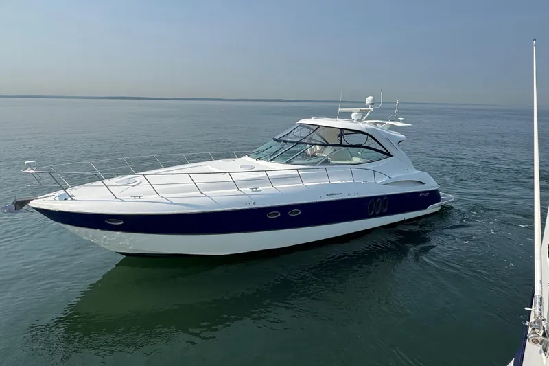 Slide: The Image of 2006 Cruisers Yachts 520 Express on calm water, showcasing sleek design and luxury features. - 1