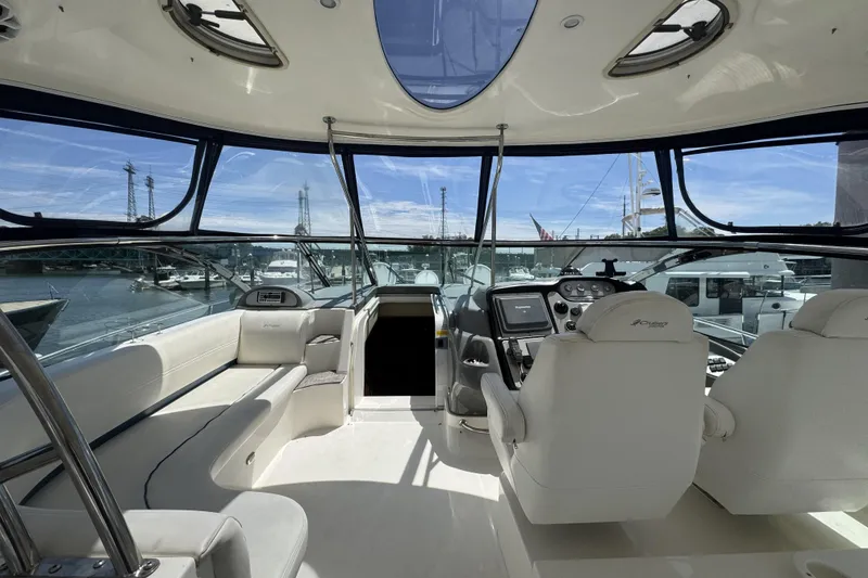 Slide: The Image of Interior view of 2006 Cruisers Yachts 520 Express, featuring helm and seating area. - 19