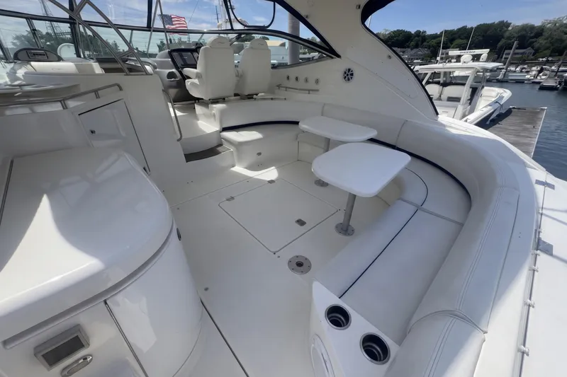 Slide: The Image of 2006 Cruisers Yachts 520 Express interior with seating and tables, docked at marina. - 15