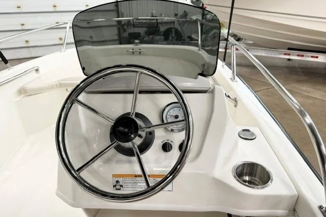 Slide: The Image of Steering console of a 2027 Boston Whaler 130 Super Sport boat, featuring a sleek design. - 6