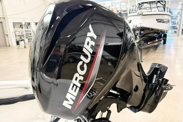 Slide: The Image of 2027 Boston Whaler 130 Super Sport with Mercury outboard engine in showroom. - 10