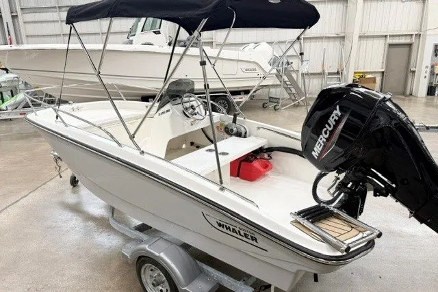 Slide: The Image of 2027 Boston Whaler 130 Super Sport boat with Mercury engine in a showroom. - 3