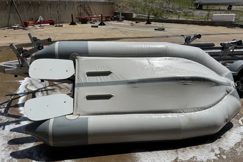 Slide: The Image of 2004 Zodiac Cadet Fastroller 310 FR Acti-V inflatable boat on a trailer, viewed from above. - 18