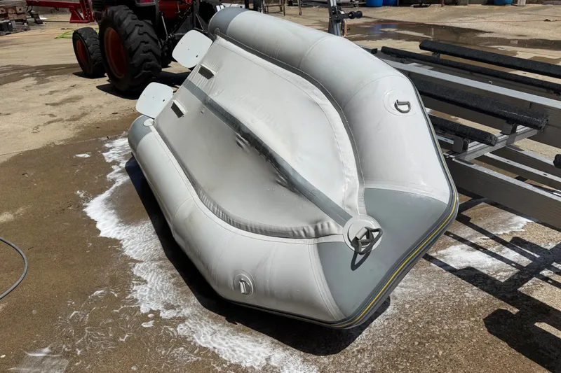 Slide: The Image of 2004 Zodiac Cadet Fastroller 310 FR Acti-V inflatable boat on a trailer. - 15