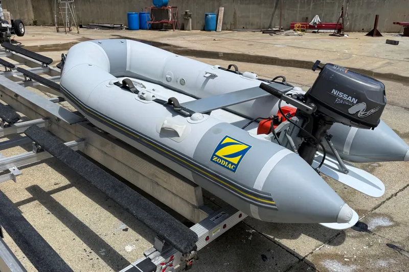 Slide: The Image of 2004 Zodiac Cadet Fastroller 310 FR Acti-V inflatable boat with Nissan outboard motor. - 12