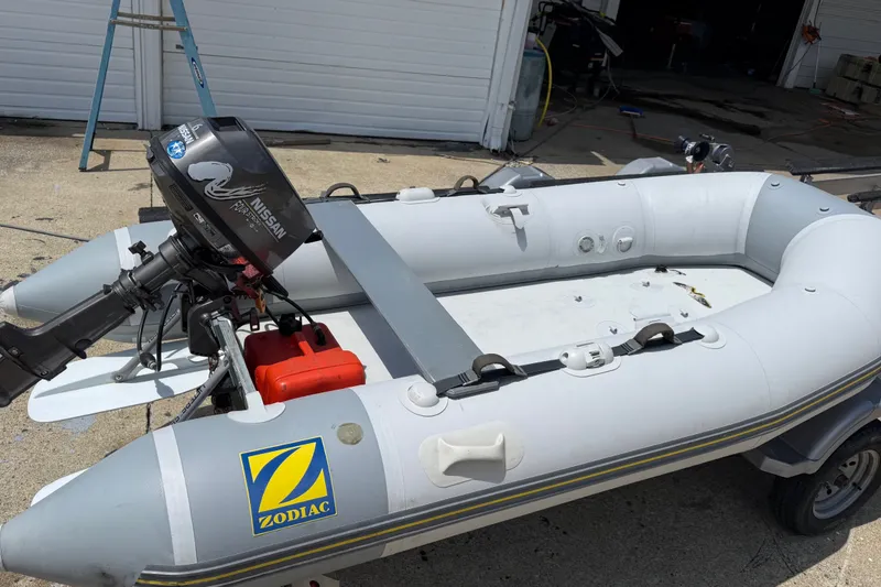 The Image of 2004 Zodiac Cadet Fastroller 310 FR Acti-V inflatable boat with Nissan outboard motor. - 8