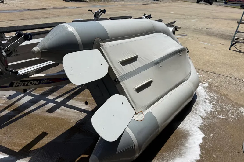 Slide: The Image of 2004 Zodiac Cadet Fastroller 310 FR Acti-V inflatable boat on trailer. - 16