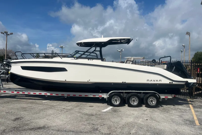 The Image of 2025 Navan S30 boat on trailer under blue sky, parked outdoors. - 1