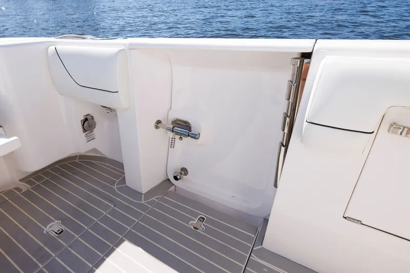 Slide: The Image of Intrepid 407 Nomad SE 2021 boat interior with sleek white seating and deck details. - 10