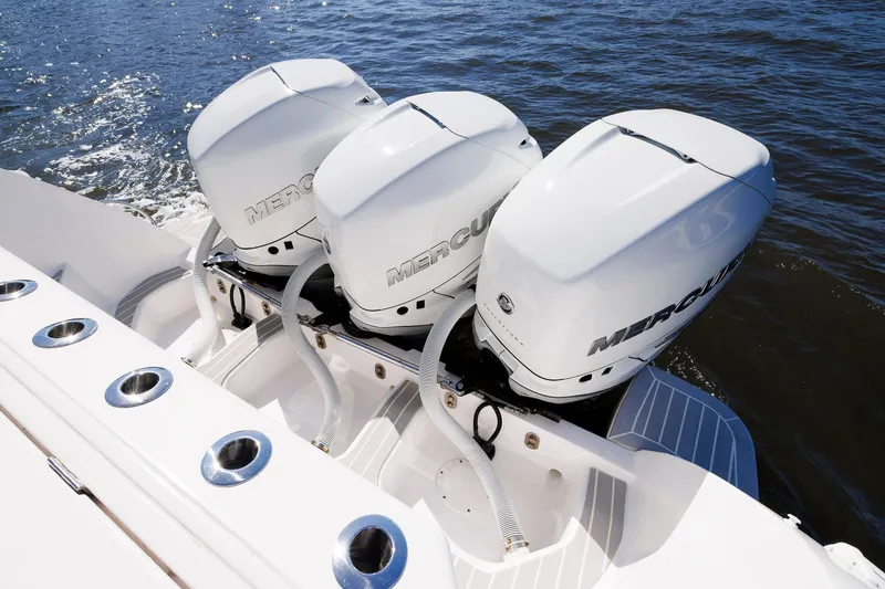 Slide: The Image of Triple Mercury outboard engines on a 2021 Intrepid 407 Nomad SE boat in water. - 13