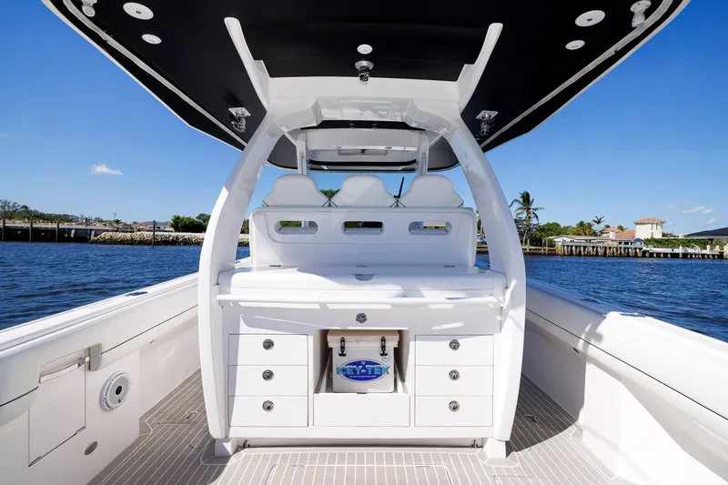 Slide: The Image of 2021 Intrepid 407 Nomad SE boat interior with sleek design and storage, cruising on a sunny day. - 7