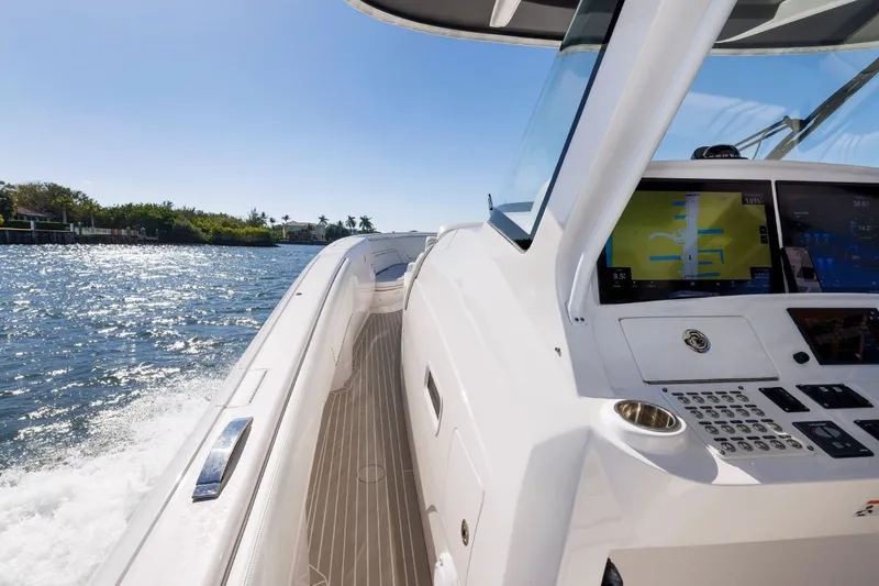 Slide: The Image of 2021 Intrepid 407 Nomad SE cruising on a sunny day, showcasing sleek design and advanced controls. - 5