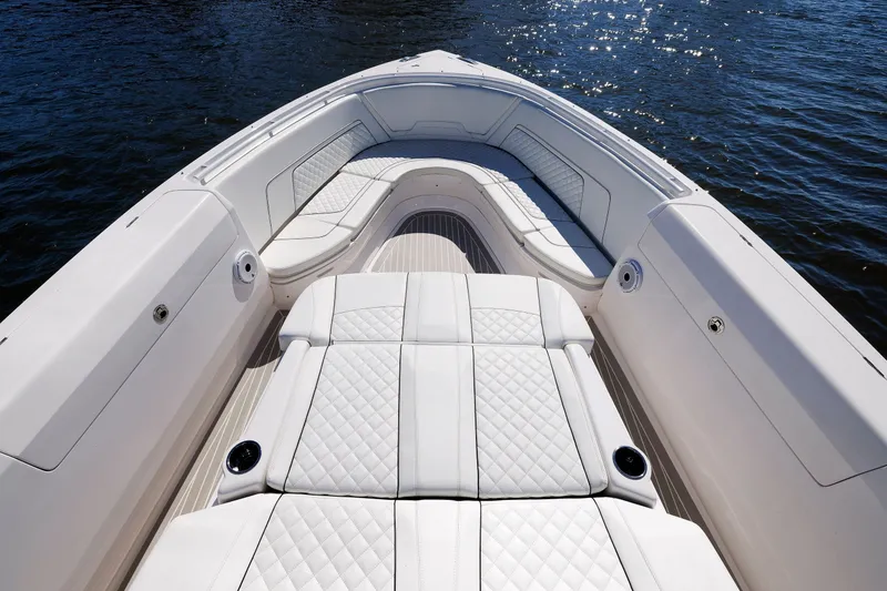 Slide: The Image of Luxurious seating on 2021 Intrepid 407 Nomad SE boat, with quilted upholstery and ocean backdrop. - 12