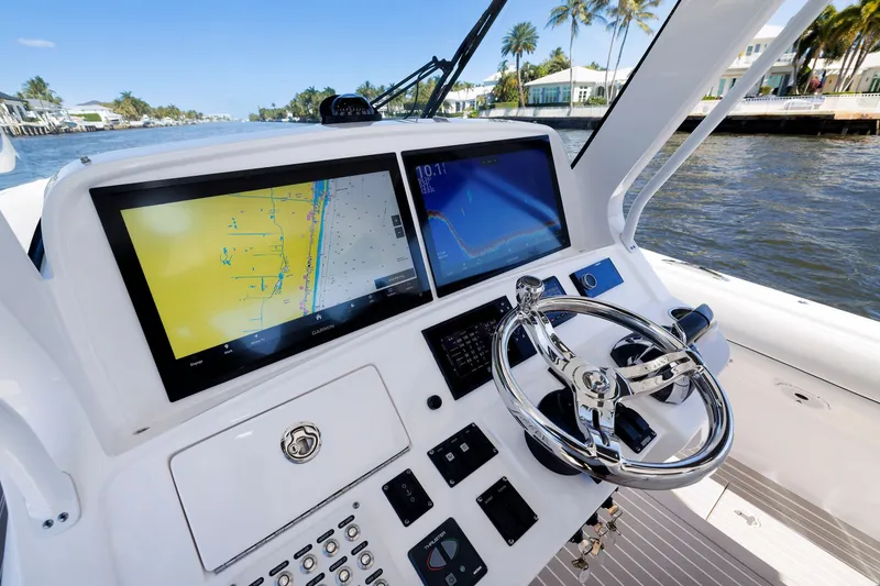 Slide: The Image of 2021 Intrepid 407 Nomad SE helm with dual navigation screens and chrome steering wheel. - 4
