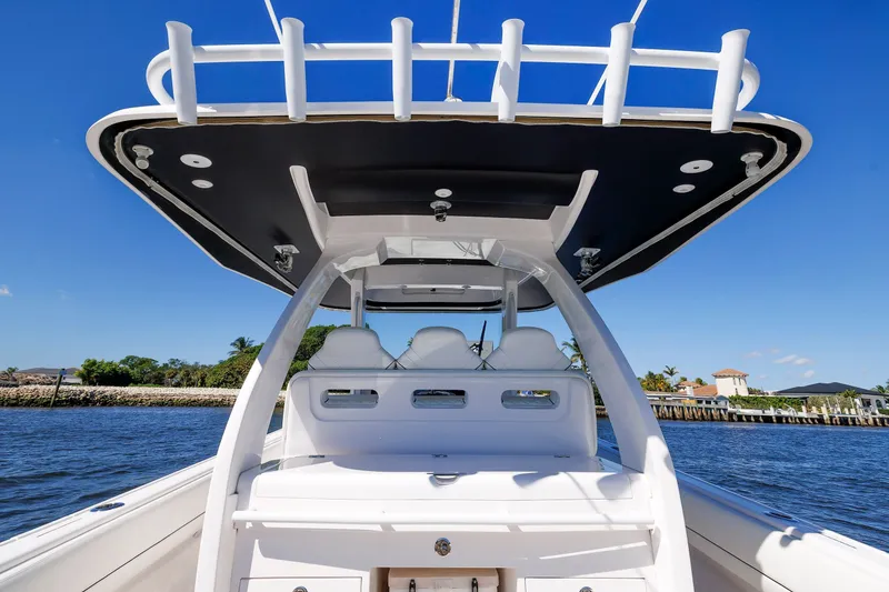 Slide: The Image of 2021 Intrepid 407 Nomad SE boat on water, showcasing sleek design and spacious seating. - 6