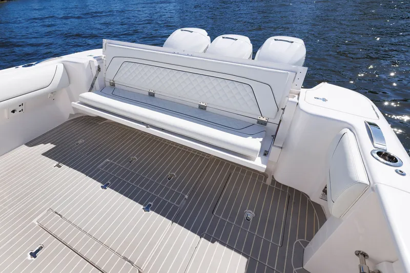Slide: The Image of 2021 Intrepid 407 Nomad SE boat interior with seating and deck, on water. - 9