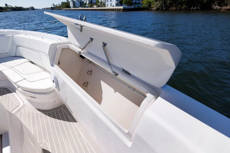 Slide: The Image of 2021 Intrepid 407 Nomad SE boat with open storage compartment on deck. - 8