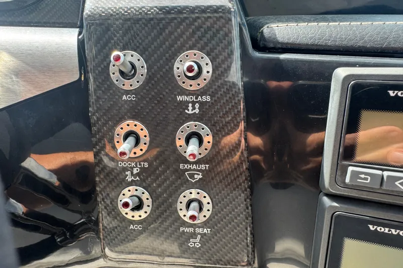 Slide: The Image of Control panel of a 2017 Four Winns H290 boat with labeled switches. - 20