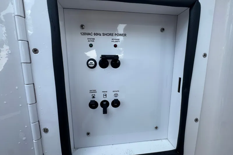 Slide: The Image of Control panel of a 2017 Four Winns H290 boat, featuring 120VAC 60Hz shore power. - 18