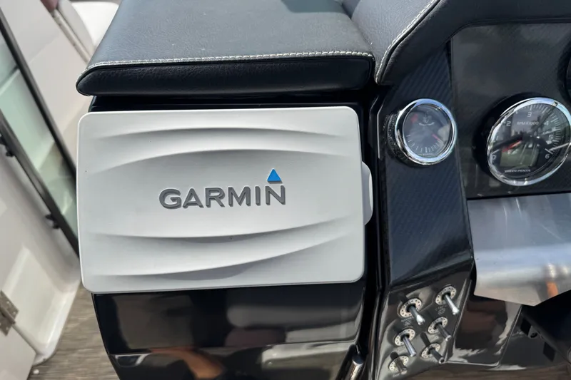 Slide: The Image of Garmin device on 2017 Four Winns H290 boat dashboard with gauges and controls. - 23