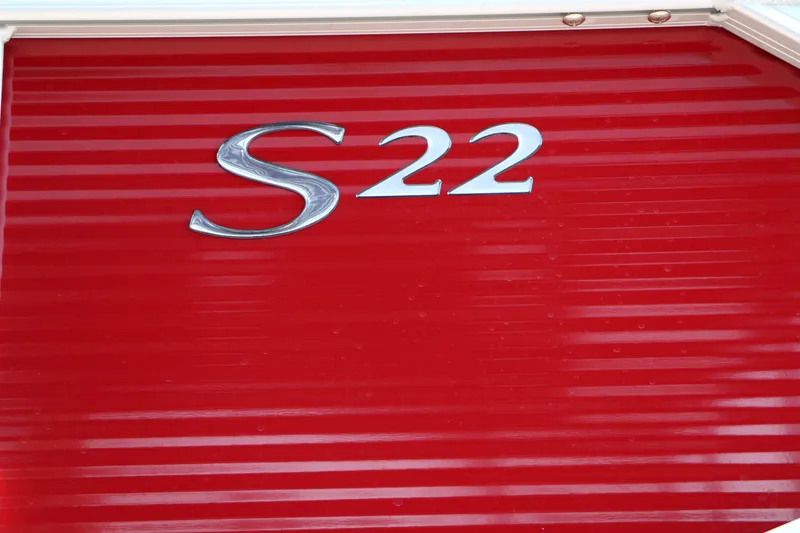 Slide: The Image of Red Bennington 22 SSR Tri-Toon boat with 'S22' emblem, 2026 model. - 10