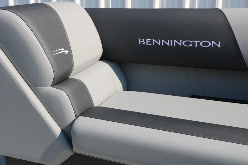 Slide: The Image of 2026 Bennington 22 SSR Tri-Toon boat seat with logo, featuring sleek gray upholstery. - 23