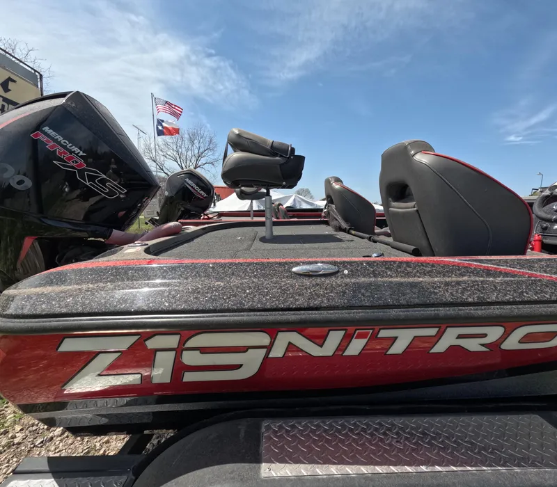 Slide: The Image of 2019 Nitro Z19 boat with seating, American flag in background, clear sky. - 17