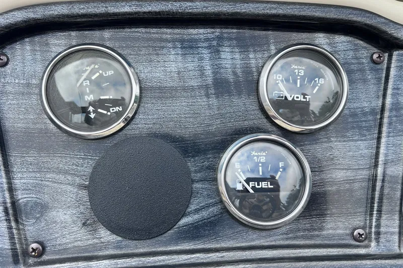 Slide: The Image of Dashboard gauges of a 2021 Godfrey Sweetwater 2086 C boat, showing trim, voltage, and fuel levels. - 18