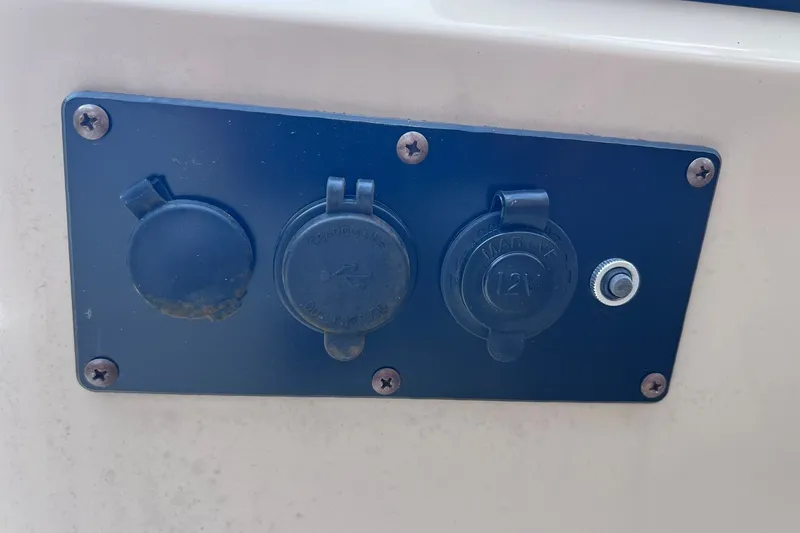Slide: The Image of Close-up of a 2021 Godfrey Sweetwater 2086 C boat's electrical panel with outlets. - 24