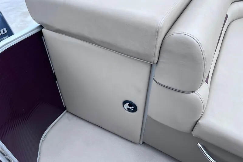 Slide: The Image of 2021 Godfrey Sweetwater 2086 C boat interior with beige seating and storage compartment. - 16