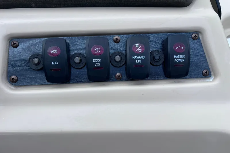 Slide: The Image of Control panel of a 2021 Godfrey Sweetwater 2086 C boat with labeled switches. - 22