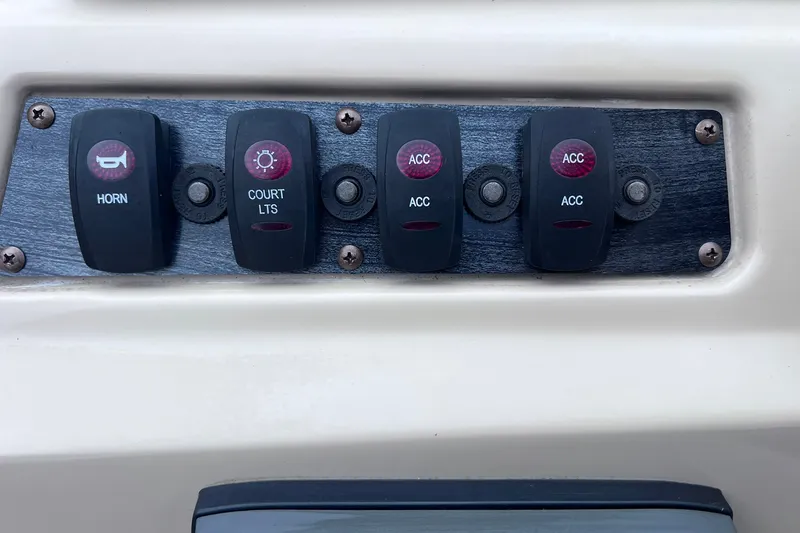 Slide: The Image of Control panel of a 2021 Godfrey Sweetwater 2086 C boat with labeled switches. - 21