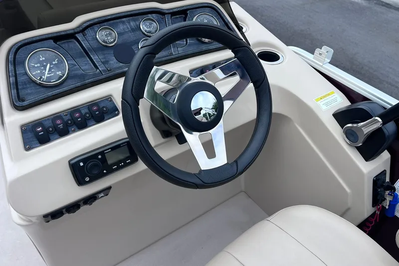 Slide: The Image of Steering console of 2021 Godfrey Sweetwater 2086 C boat with gauges and controls. - 17