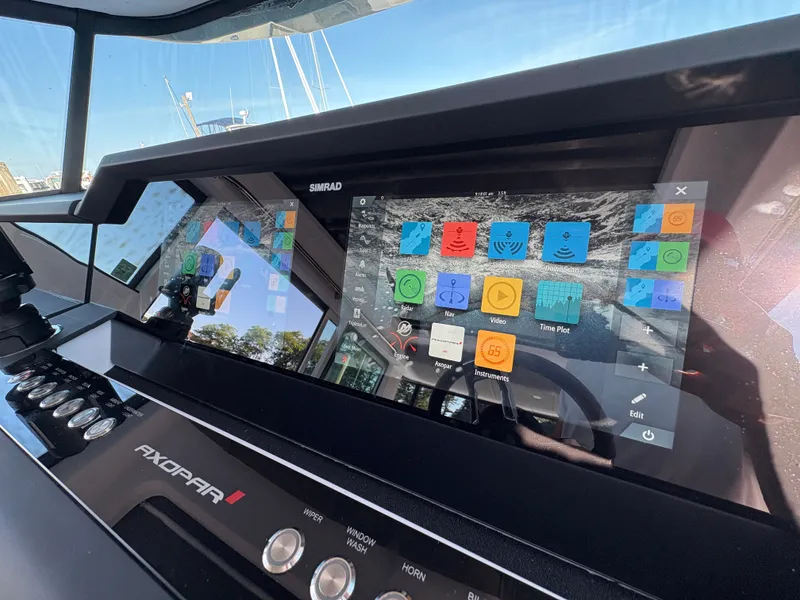 Slide: The Image of The image shows the dashboard of a 2024 Axopar 37 XC Cross Cabin with a modern navigation system. - 21
