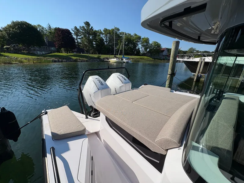 Slide: The Image of The image shows the stern of a 2024 Axopar 37 XC Cross Cabin with two outboard engines. - 44