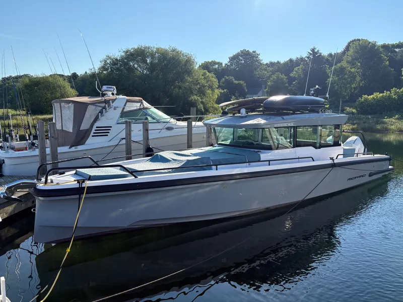 The Image of 2024 Axopar 37 XC Cross Cabin docked in a serene setting. - 0