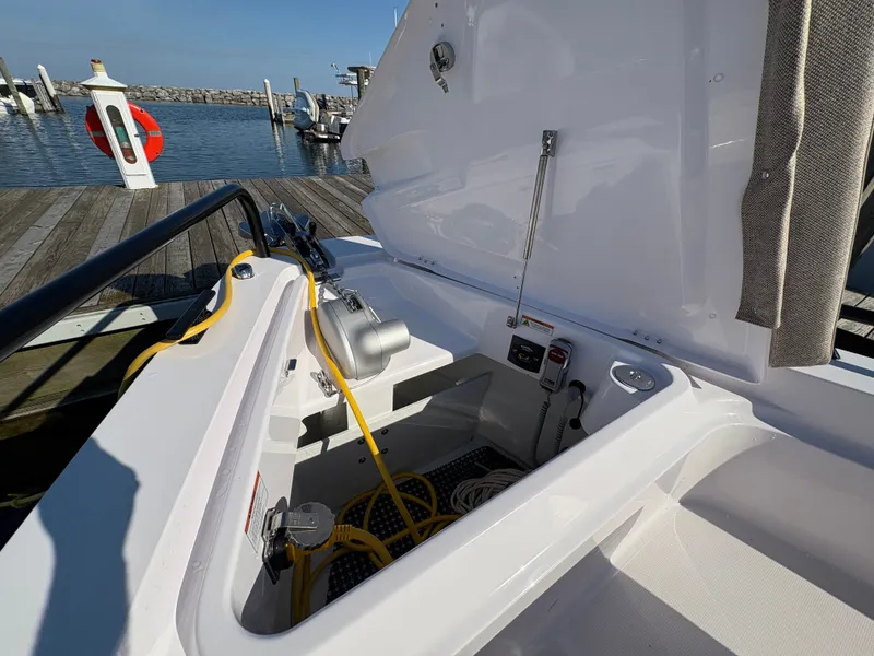 Slide: The Image of The image shows the storage area of a 2024 Axopar 37 XC Cross Cabin boat at the dock. - 38
