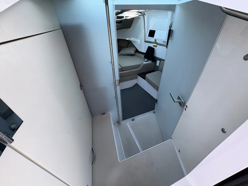 Slide: The Image of Interior of the 2024 Axopar 37 XC Cross Cabin with modern seating and a small table. - 26