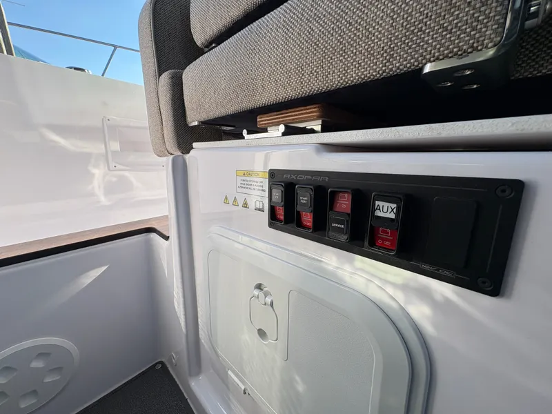 Slide: The Image of The image shows the interior of a 2024 Axopar 37 XC Cross Cabin with switches and cushions. - 24