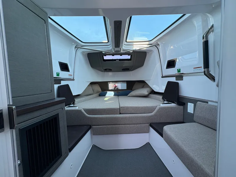 Slide: The Image of Interior of the 2024 Axopar 37 XC Cross Cabin with modern seating and large windows. - 30