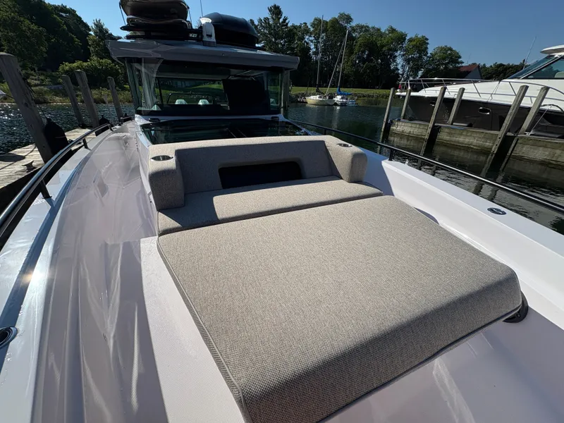 Slide: The Image of 2024 Axopar 37 XC Cross Cabin with spacious sun deck and modern design at the dock. - 39