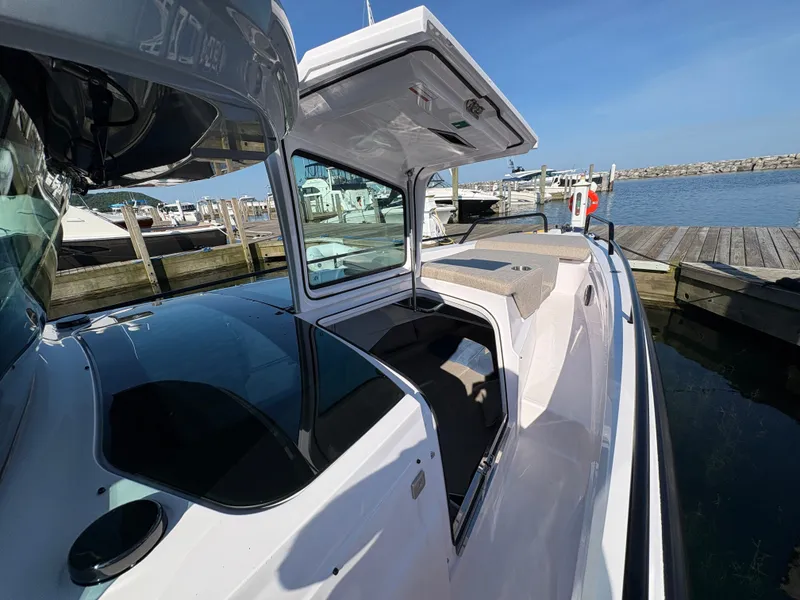 Slide: The Image of The image shows a 2024 Axopar 37 XC Cross Cabin boat at a dock. - 42
