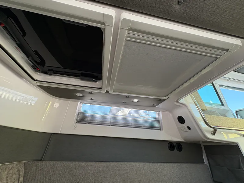 Slide: The Image of Interior of the 2024 Axopar 37 XC Cross Cabin with skylights and gray upholstery. - 15