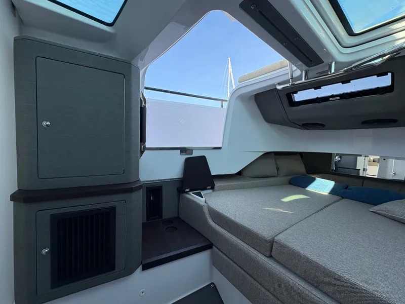 Slide: The Image of Interior of the 2024 Axopar 37 XC Cross Cabin with gray upholstery and skylights. - 32