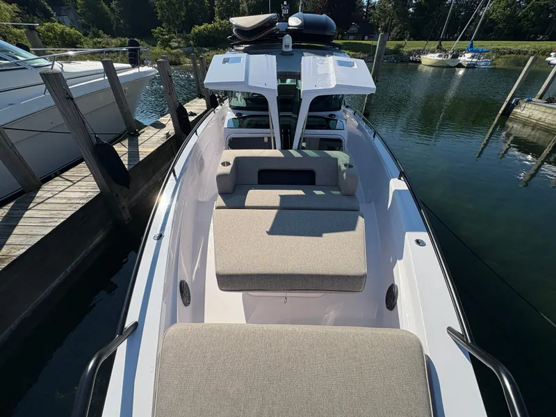 Slide: The Image of The image shows the foredeck of a 2024 Axopar 37 XC Cross Cabin docked at a pier. - 36