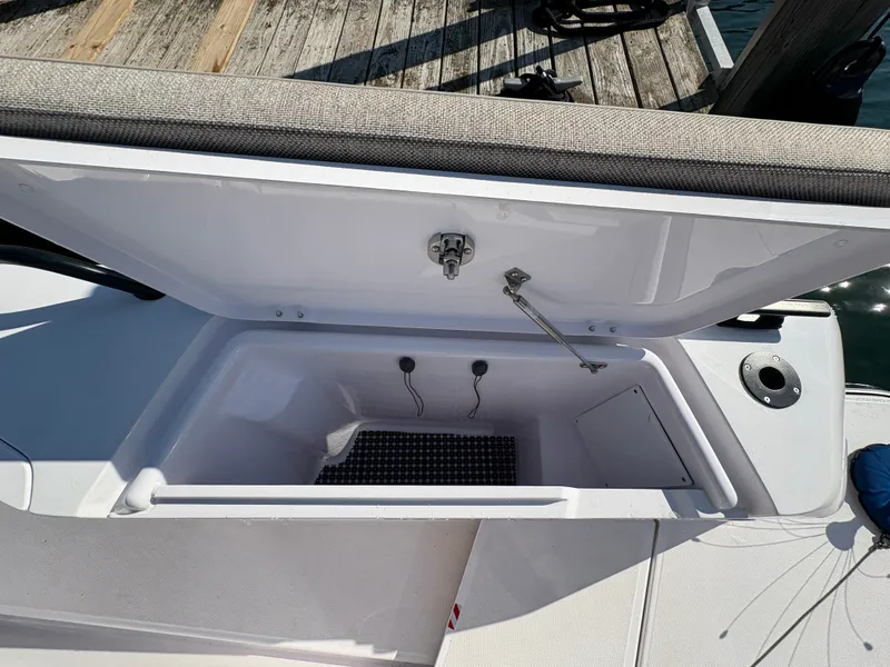 Slide: The Image of An open storage compartment on a boat with a cushioned lid and non-slip mat inside. - 47