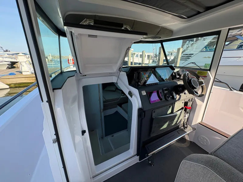 Slide: The Image of The image shows the cockpit of a 2024 Axopar 37 XC Cross Cabin with modern instruments. - 25