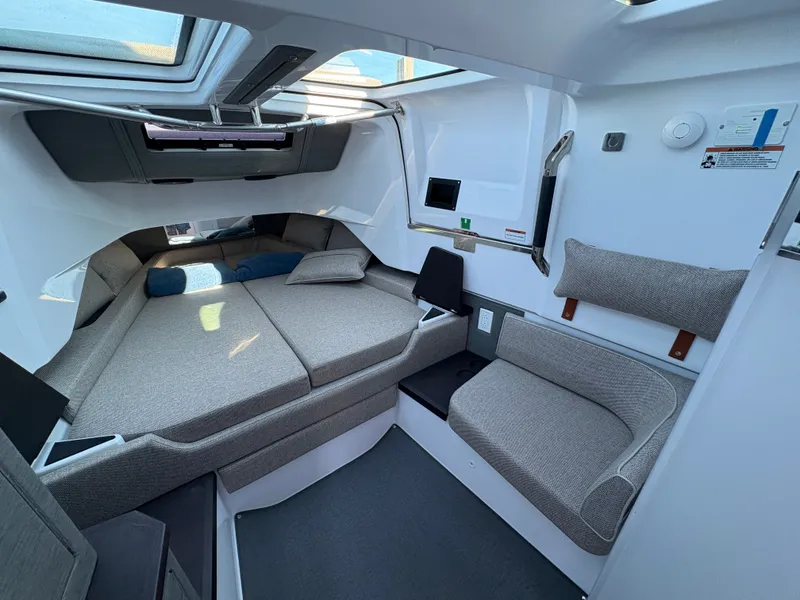 Slide: The Image of Interior of the 2024 Axopar 37 XC Cross Cabin with gray upholstery and a large bed. - 31